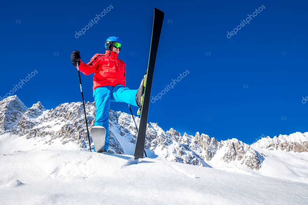 Young happy skier ready for skiing on the top of  Alps. 