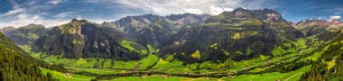 Aerial view of Elm village and Swiss mountains - Piz Segnas, Piz Sardona, Laaxer Stockli from Ampachli, Glarus, Switzerland, Europe.  clipart