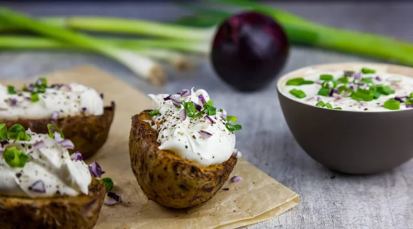 Baked jacket potatoes stuffed with curd and spring onion