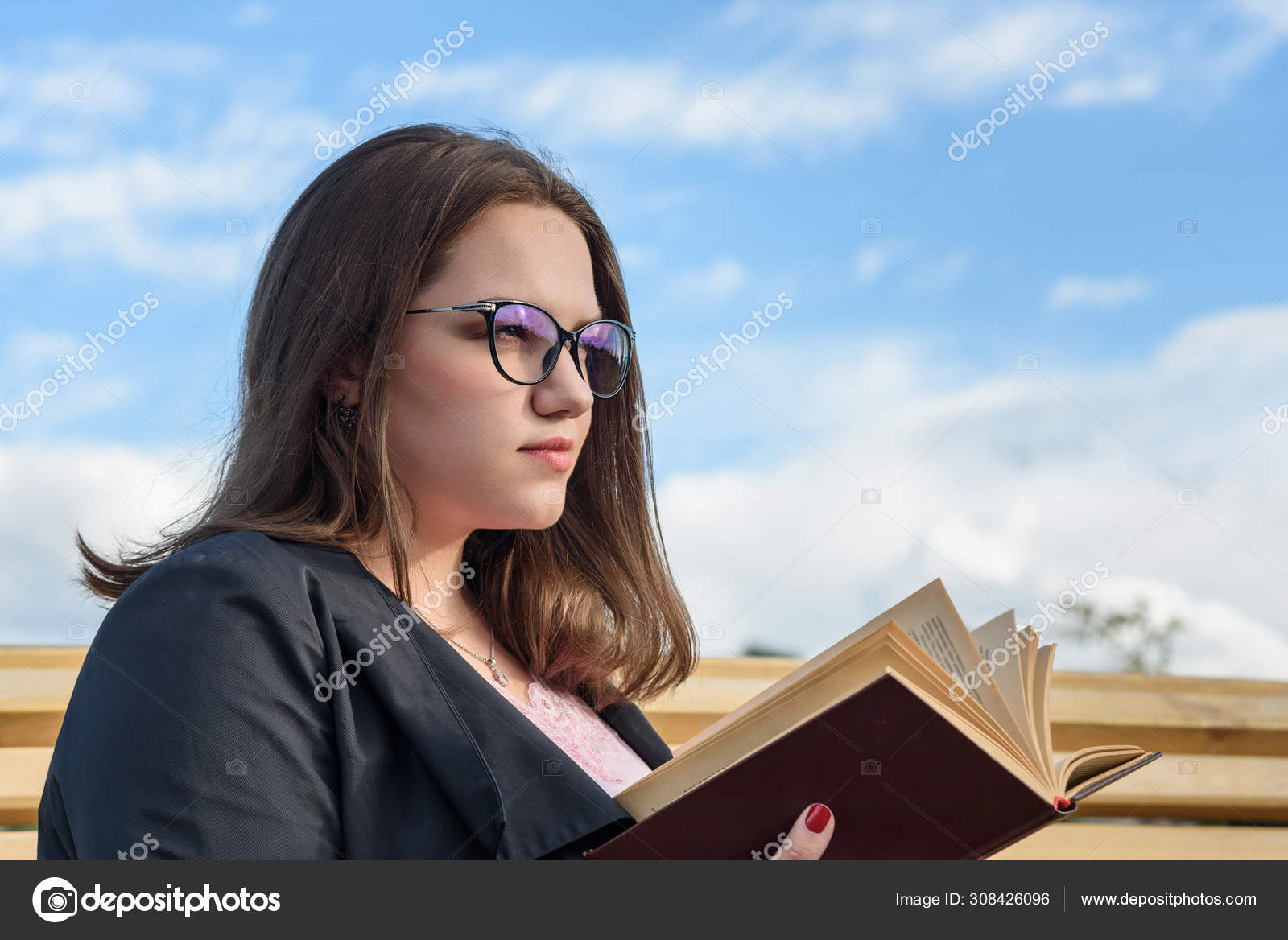 Brunette Girl Reading Book On Bench On The Street Girl In Black