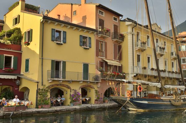 Malcesine, Italy - August 7, 2014: Color houses at the banks of the Lake Garda in the village of Malcesine, Italy.