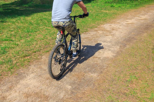 Man riding a bike on a forest trail