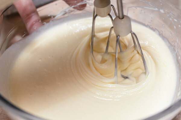Mixing the ingredients of biscuit dough with an electric mixer