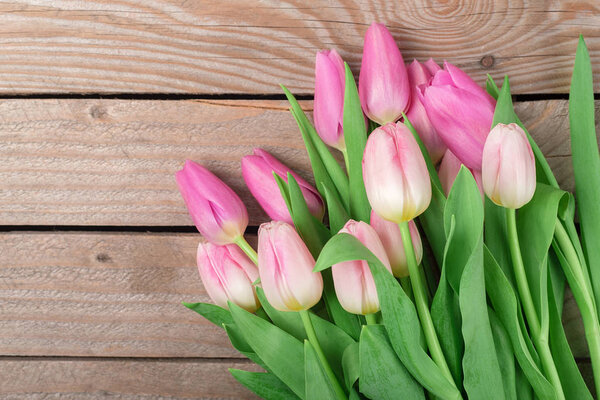 Bouquet of tulips on the wooden background