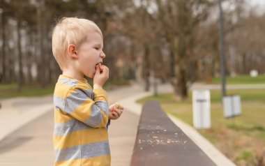 Aç çocuk parkta yemek 