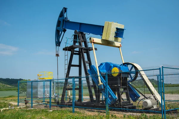 Oil pump machine over the blue sky