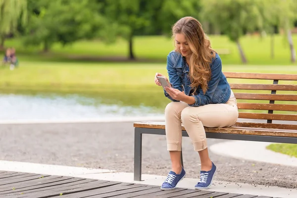 Young Woman Sitting Bench Use Her Phone Park — Stock Photo, Image