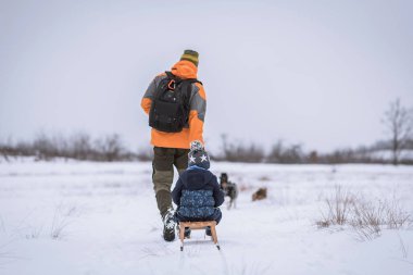 Genç adam ve oğlu bir karlı gün kış parkta halletme