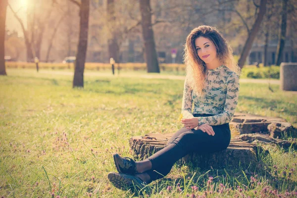 Vintage photo of a beautiful woman in park — Stock Photo, Image