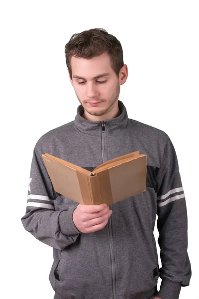 Bonito jovem lendo um livro antigo sobre fundo branco — Fotografia de Stock