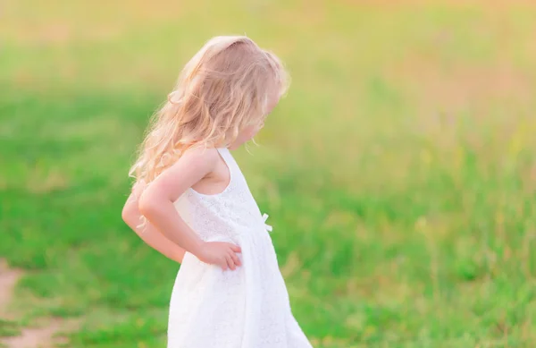 Beautiful blond little girl in the field — Stock Photo, Image