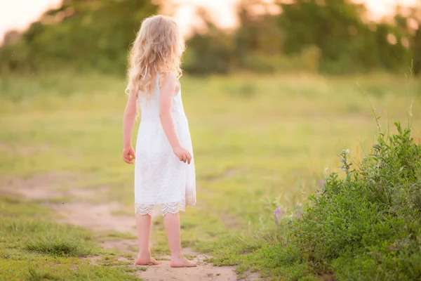 Beautiful blond little girl in the field — Stock Photo, Image