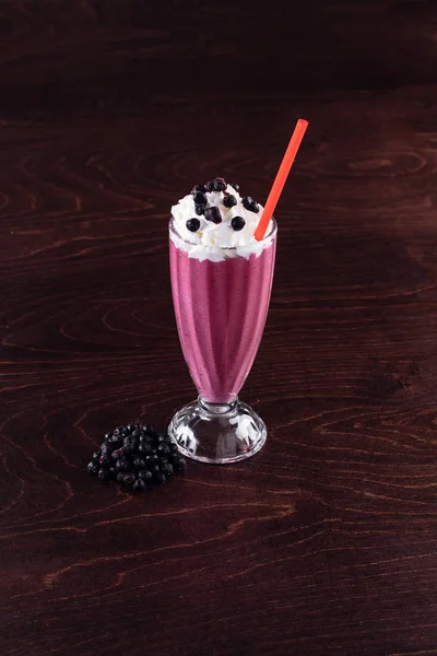 Milkshake with whipped cream and berries — Stock Photo, Image