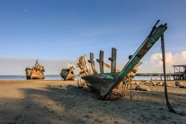 Broken and old fishing boat , Three Ship Wreck in Kuala Penyu, Sabah, Malaysia , Abandoned Ship at sabah borneo malaysia Image has grain or blurry or noise and soft focus when view at full resolution.