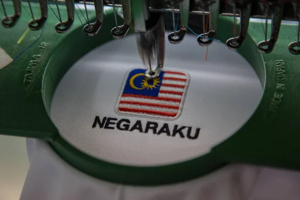 Close-up Of embroidery Malaysia Logo with Wording NEGARAKU (My Country) on white uniform