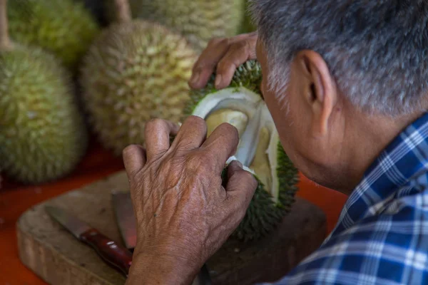 old man hand open the king of fruit \