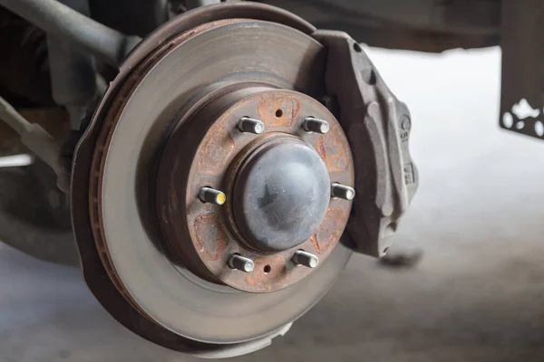 Closeup of car disc brake at car workshop-Technical concept