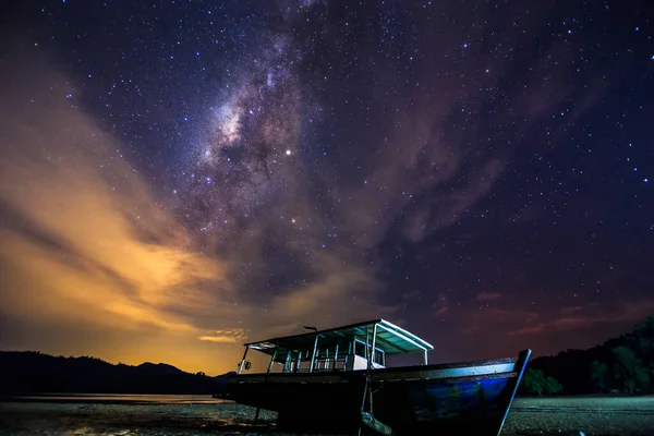 Amazing beautiful of night sky Milky Way Galaxy with abandon fisherman boat - Travel Concept