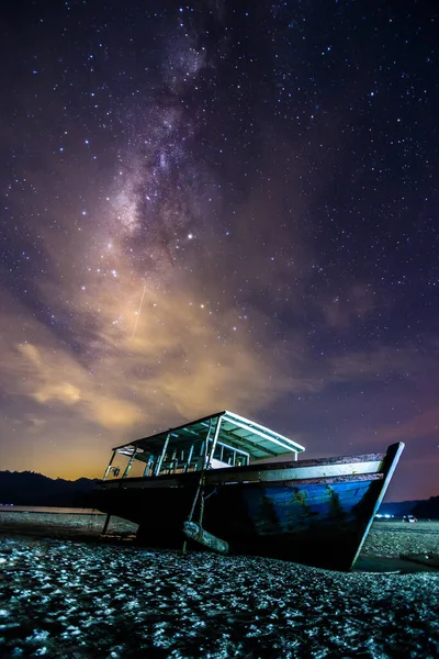 Amazing beautiful of night sky Milky Way Galaxy with abandon fisherman boat - Travel Concept