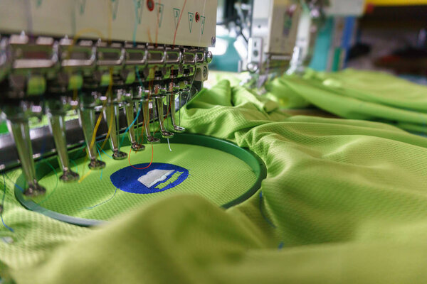 Embroidery machine needle in Textile Industry at Garment Manufacturers, Embroidery t-shirt in progress , Embroidery needle, Needle with thread (selective focus and soft focus)