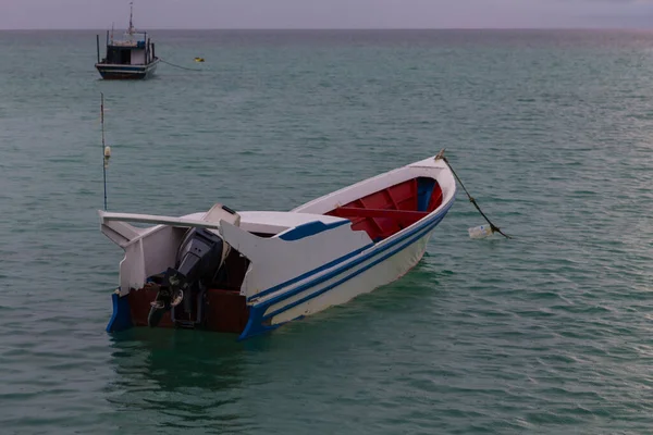 Fishing boat in the sea with anchored in the sea - Travel Concept