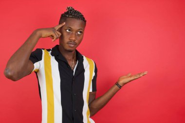 Yakışıklı genç adamın kafası karışmış ve avuç içi açık fotokopi alanı ve alnını göstermekten rahatsız olmuş. Bunu bir düşün..