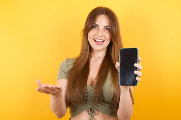 Caucasian Woman Studio Presenting Smartphone — Stock Photo, Image