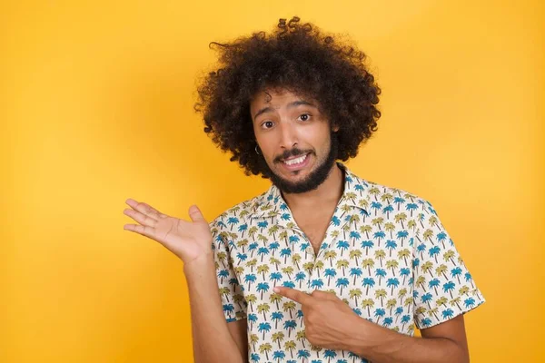 handsome young man  holding hand showing empty space