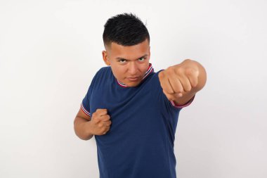 Yakışıklı genç adam dövüşmek için yumruk atıyor, agresif ve öfkeli saldırı, tehdit ve şiddet