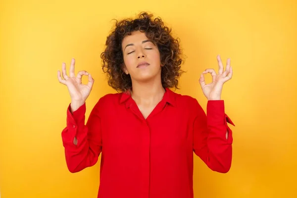 beautiful young woman smiling with eyes closed, doing meditation gesture with fingers. Yoga concept.