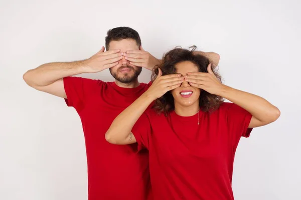 man and woman in studio, Covering eyes and mouth with hands