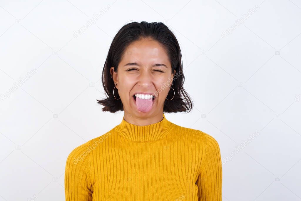 beautiful young woman  sticking tongue out happy with funny expression. Emotion concept.