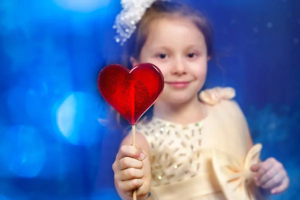 Girl Child Yellow Dress White Bow Holding Lollipop Heart Stock Image