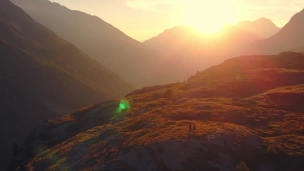 Aerial Couple Backpackers Hiking Mountain Top Rocky Mountain Peak Backlight — Stock Video