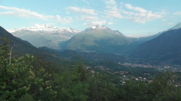 Aéreo Sobrevoando Vale Floresta Verde Primavera Cordilheira Coberta Neve Aldeias — Vídeo de Stock