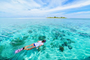 Mercan resifinde şnorkelle yüzen kadın tropik Karayip denizinde, turkuaz mavi suda. Endonezya Wakatobi takımadaları, deniz milli parkı, turist dalış merkezi