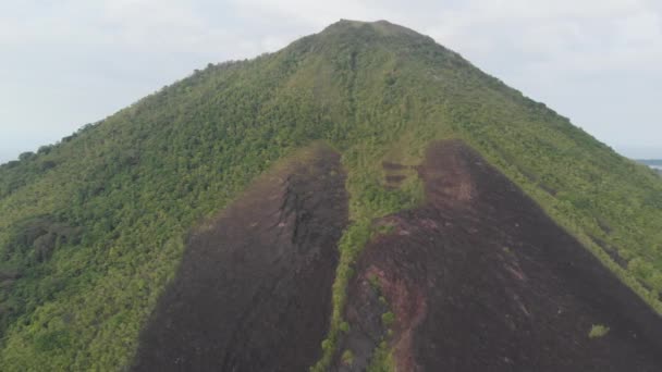 Aérea: volando sobre las Islas Banda volcán activo Gunung Api flujos de lava Maluku Indonesia exuberante bosque verde turquesa agua arrecife de coral pintoresco destino de viaje. Perfil de color D-log cinelike nativo — Vídeo de stock