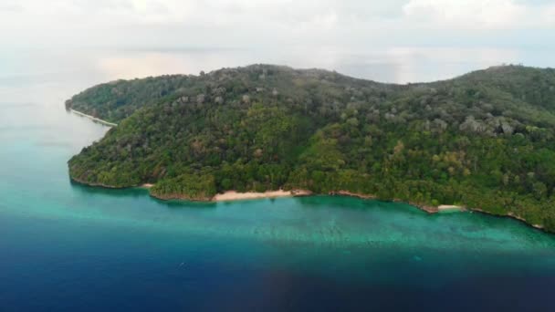 飞越热带哈塔岛白沙海滩班达群岛马鲁库印度尼西亚郁郁葱葱的绿色森林绿松石水珊瑚礁风景旅游目的地 — 图库视频影像