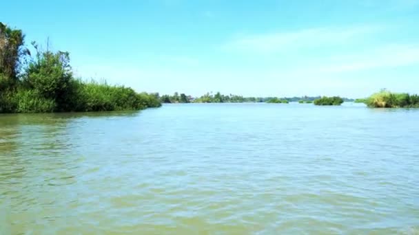 メコン川4001島シファンドンラオスの有名な観光地 澄んだ青空 緑の熱帯植物を旅するボートのバックパック — ストック動画