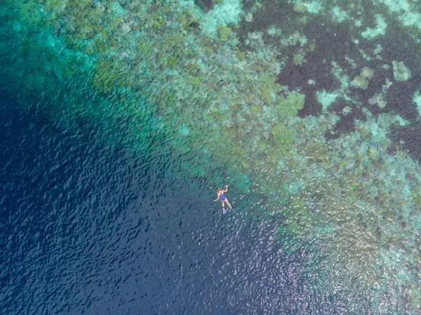 Aerial top down people snorkeling on coral reef tropical caribbean sea, turquoise blue water. Indonesia Wakatobi archipelago, marine national park, tourist diving travel destination — Stock Photo, Image