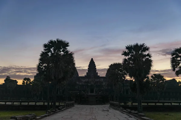 Angkor Wat cielo dramático al amanecer silueta de la fachada principal reflexión sobre el estanque de agua. Templo de fama mundial en Camboya . — Foto de Stock