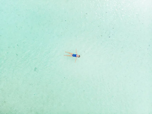 Kvinna som simmar i Karibiska havet turkos transparent vatten. Antenn uppifrån och ned, minimal komposition. Exotisk semester välbefinnande Fitness. — Stockfoto