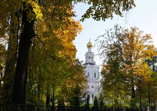 Church and Dome of the old Orthodox church with a cross through the autumn foliage of trees against clean sky. Architecture. Cathedral of the Russian Church in Moscow. Popular touristic lanmdark
