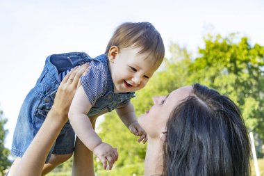 Anne ve bebek yeşil çim üzerinde yalan