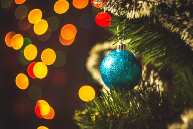 Mavi Noel top yuvarlak garland ışıklar arka plan çok renkli bokeh ile Ladin Noel ağacı üzerinde