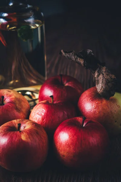 Close Red Apples Oil Bottle Wooden Table Low Key — Stock Photo, Image