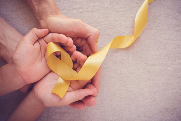 Adult Child Hands Holding Yellow Gold Ribbon Sarcoma Awareness Bone — Stock Photo, Image