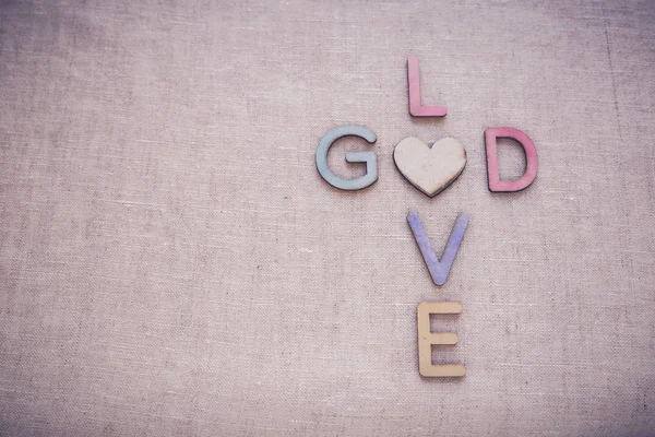 Love God wooden words, toning copy space background