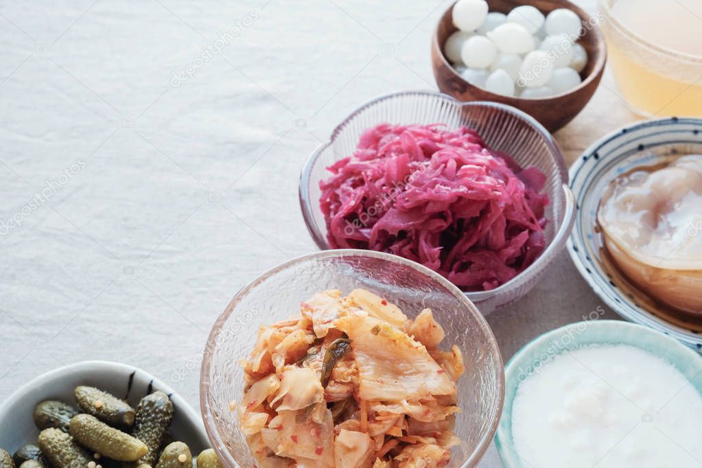 variety of fermented probiotic foods on light background