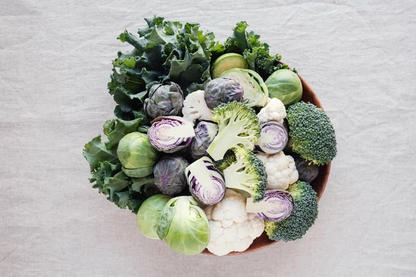 Cruciferous vegetables, cauliflower,broccoli, Brussels sprouts, kale in wooden bowl, reducing estrogen dominance, ketogenic diet — Stock Image Cruciferous Vegetables Cauliflower Broccoli Brussels Sprouts Kale Wooden Bowl Reducing Stock Photo